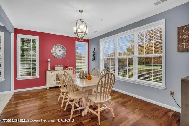 a view of a dining room with furniture and chandelier