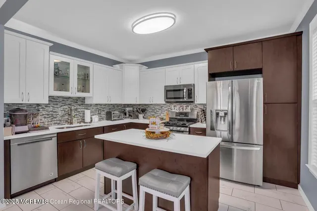 a kitchen with a sink a stove cabinets and refrigerator