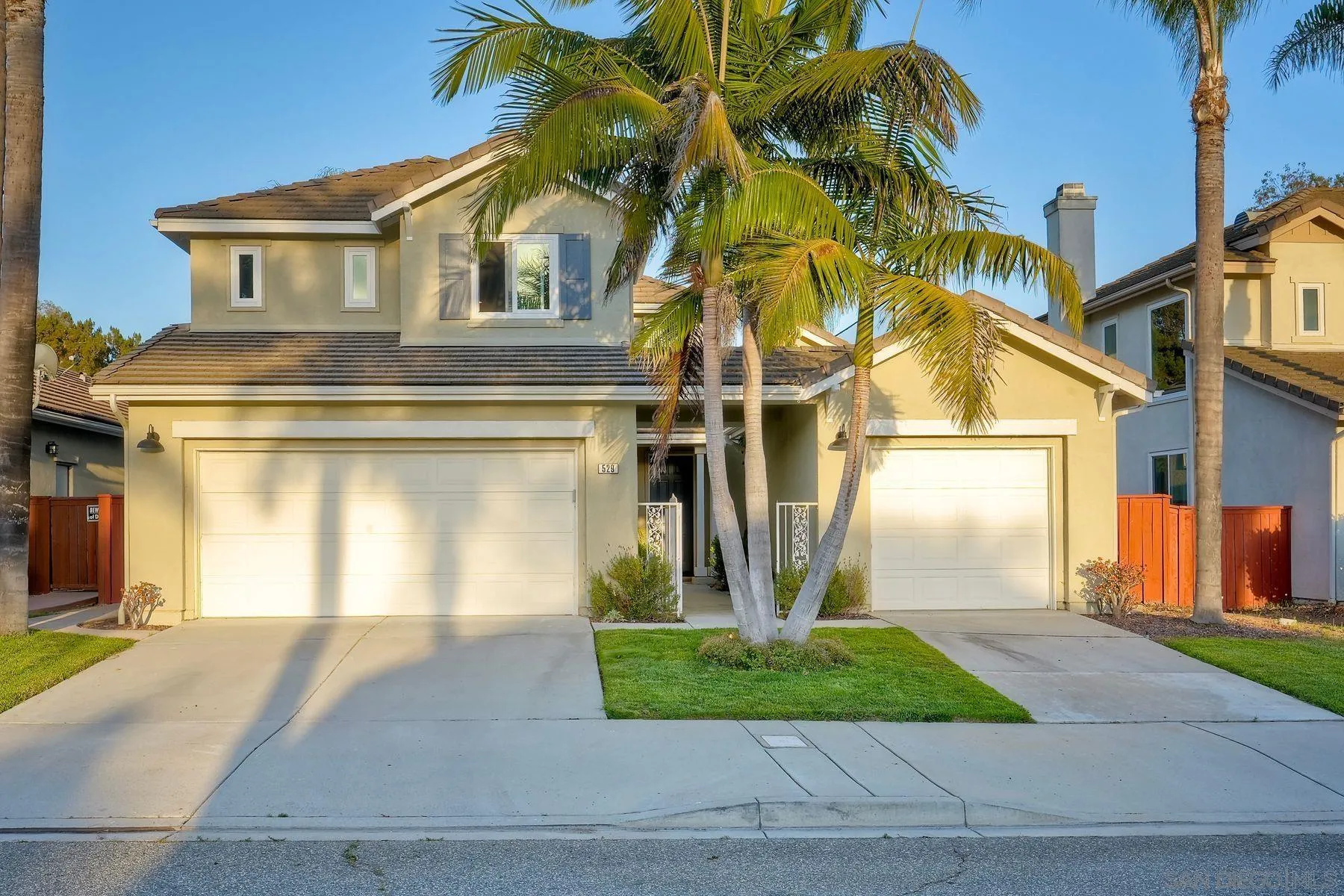 529 Peach Tree Way San Marcos, CA 92069 - Photo 2 of 30 a front view of a house with a yard and garage
