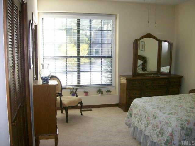 913 Albany Court Raleigh, NC 27615 - Photo 7 of 10 a bedroom with a bed and a large window