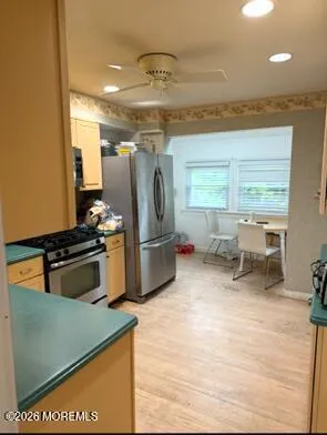 a kitchen with stainless steel appliances granite countertop a sink and a refrigerator