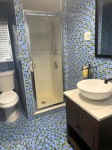 a bathroom with a sink toilet and shower
