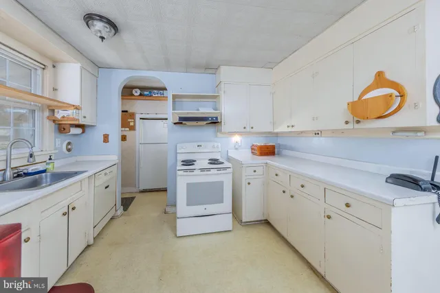 a kitchen with cabinets appliances and a sink