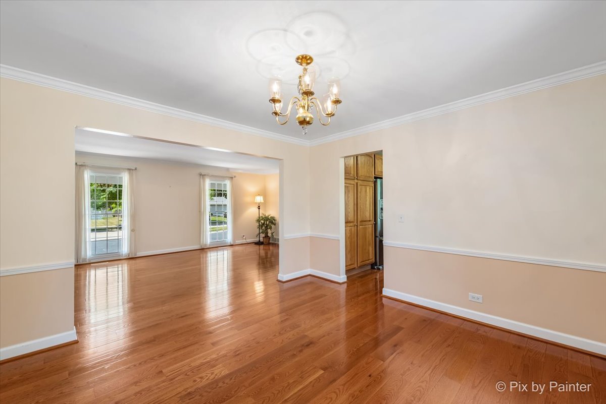 1599 Burning Trail Wheaton, IL 60189 - Photo 11 of 64 a view of an empty room with a window and wooden floor