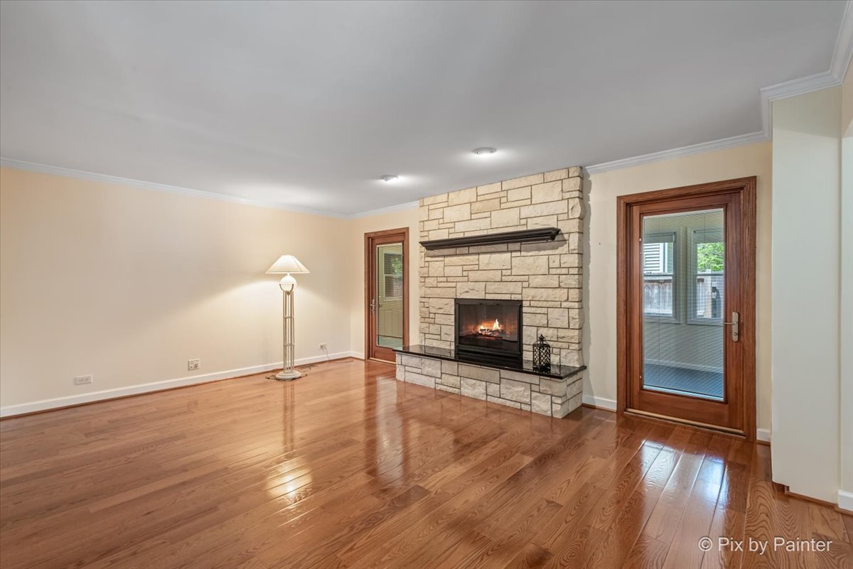 1599 Burning Trail Wheaton, IL 60189 - Photo 13 of 64 a view of empty room with wooden floor and fireplace
