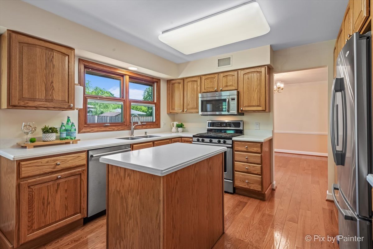 1599 Burning Trail Wheaton, IL 60189 - Photo 19 of 64 a kitchen with stainless steel appliances granite countertop a sink stove and refrigerator