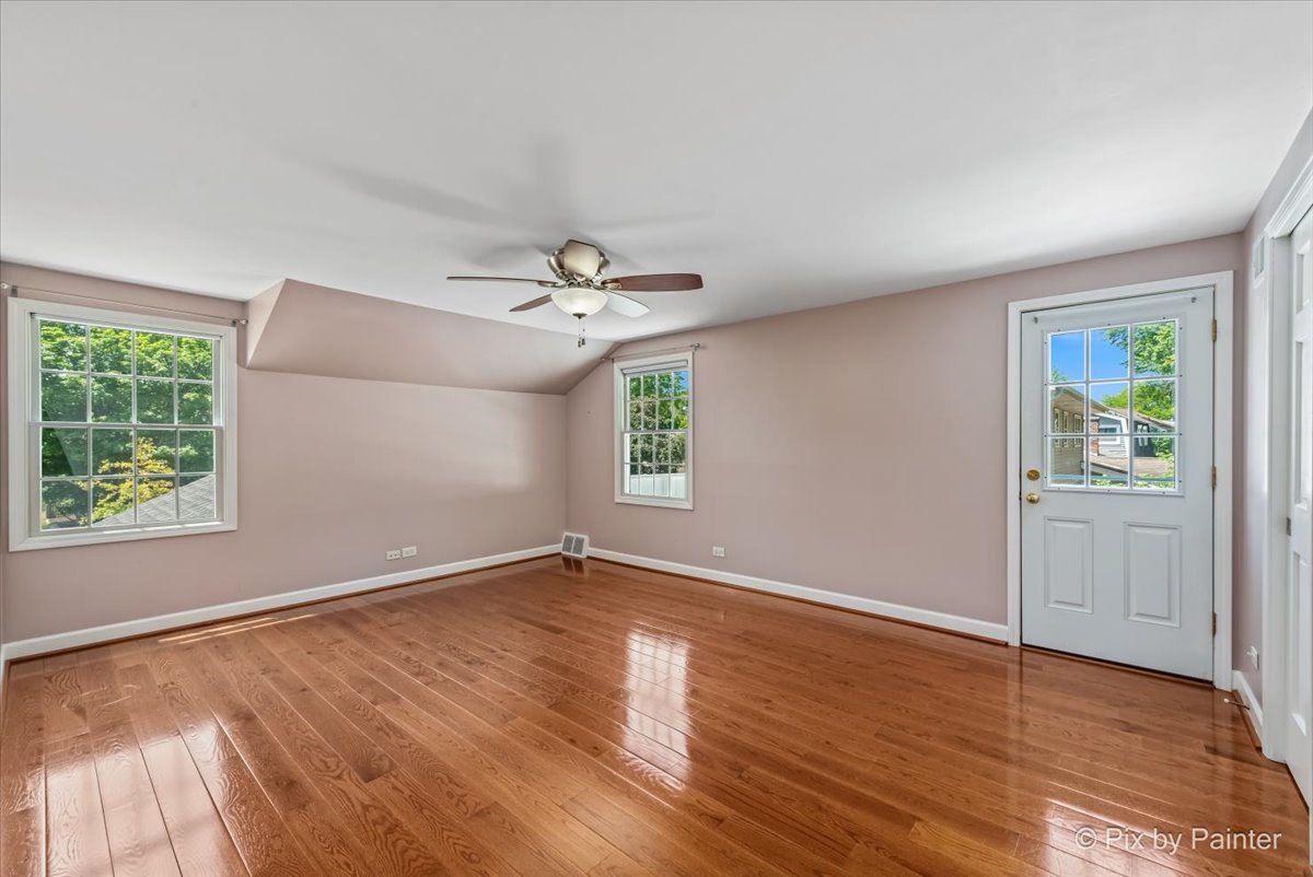 1599 Burning Trail Wheaton, IL 60189 - Photo 25 of 64 a view of an empty room with wooden floor and a window