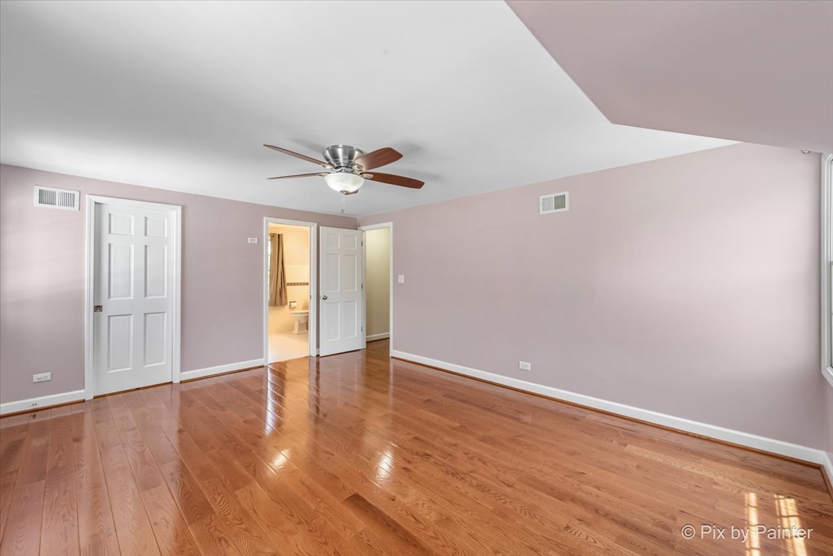 1599 Burning Trail Wheaton, IL 60189 - Photo 26 of 64 a view of an empty room with wooden floor and a window