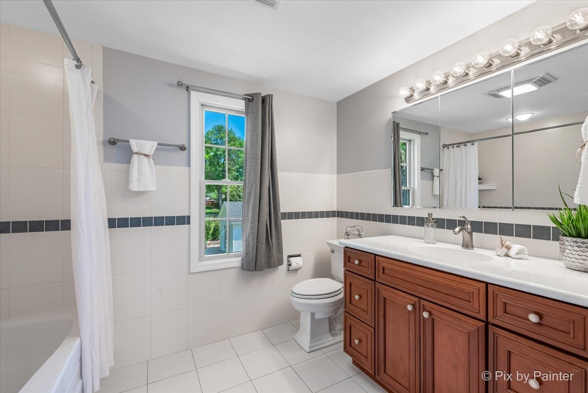 1599 Burning Trail Wheaton, IL 60189 - Photo 27 of 64 a spacious bathroom with a toilet sink and mirror
