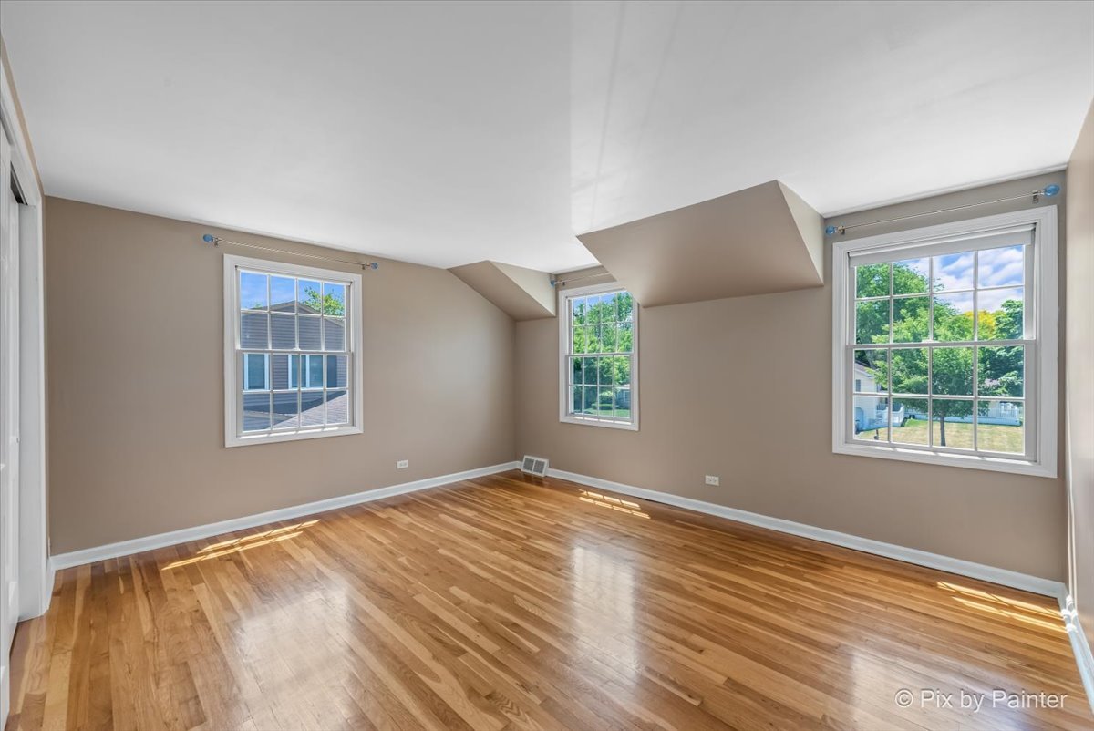 1599 Burning Trail Wheaton, IL 60189 - Photo 31 of 64 a view of an empty room with wooden floor and a window