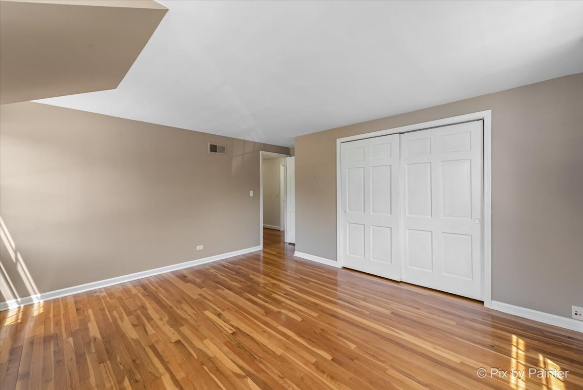 1599 Burning Trail Wheaton, IL 60189 - Photo 32 of 64 a view of an empty room with wooden floor