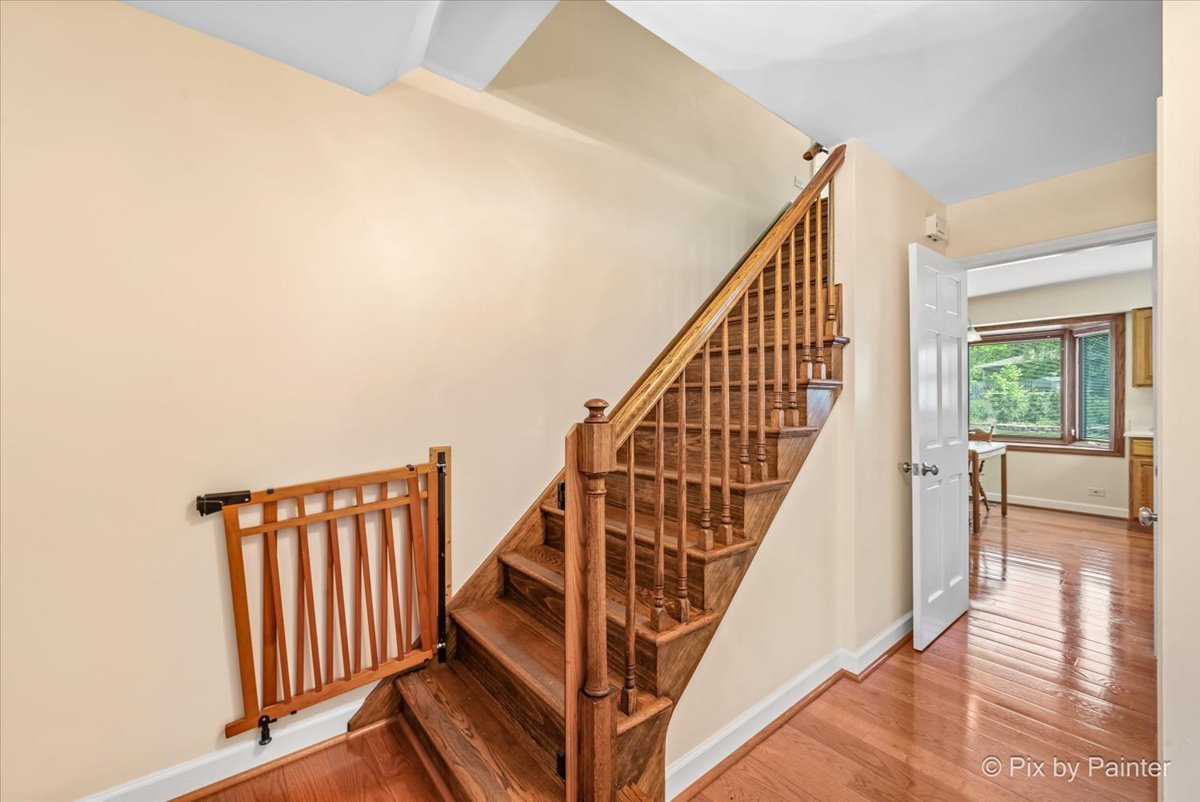 1599 Burning Trail Wheaton, IL 60189 - Photo 4 of 64 a view of staircase with wooden floor and a large window