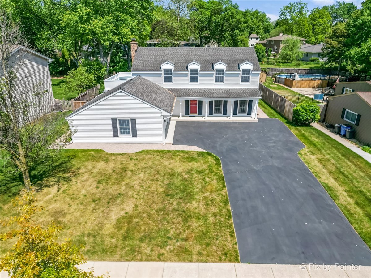 1599 Burning Trail Wheaton, IL 60189 - Photo 61 of 64 a front view of house with yard and trees in the background
