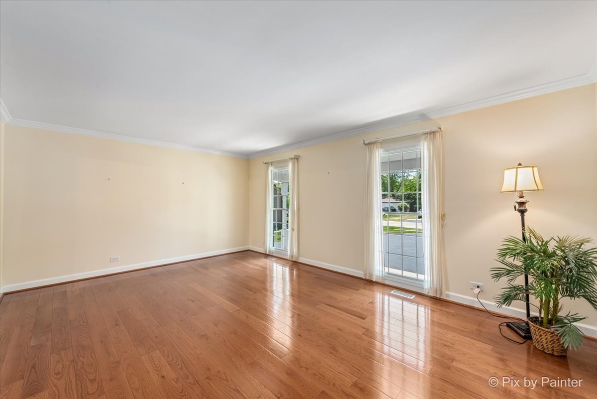 1599 Burning Trail Wheaton, IL 60189 - Photo 8 of 64 a view of an empty room with a window and wooden floor
