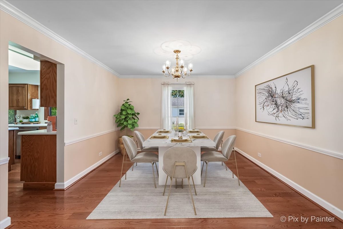 1599 Burning Trail Wheaton, IL 60189 - Photo 9 of 64 a dining room with wooden floor a chandelier a wooden table and chairs