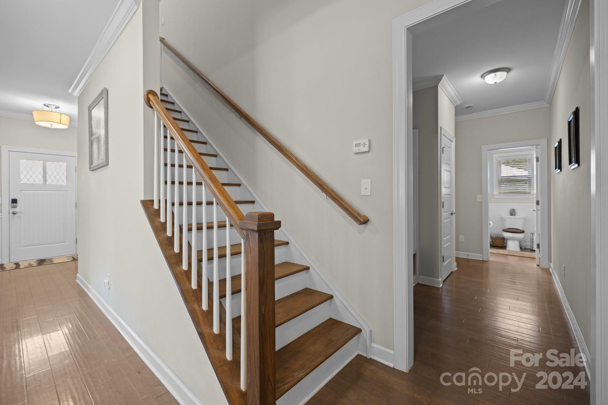 2061 Fuschia Court Fort Mill, SC 29708 - Photo 16 of 45 a view of a hallway with wooden floor and staircase