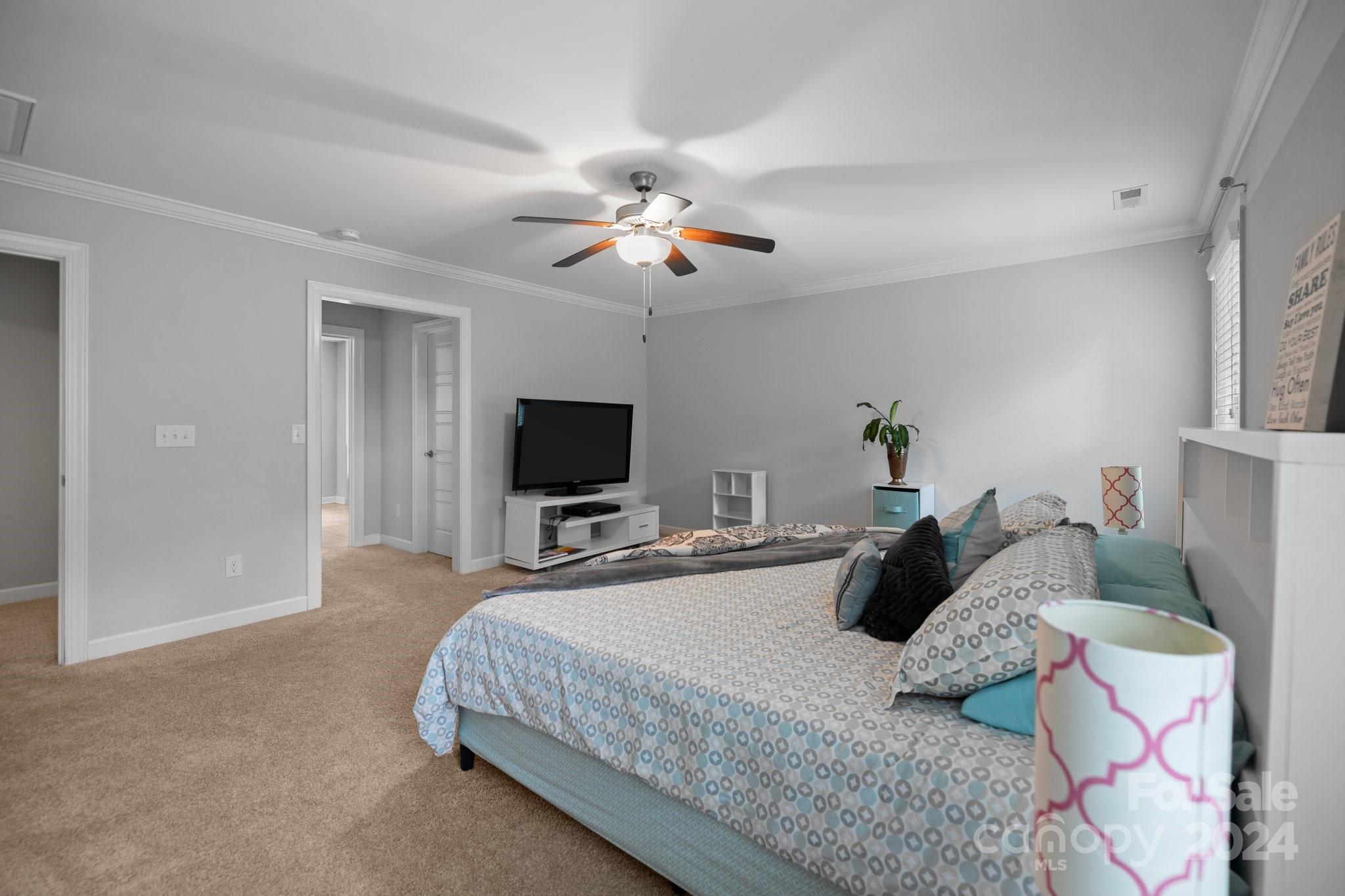 2061 Fuschia Court Fort Mill, SC 29708 - Photo 18 of 45 a bedroom with a bed and a flat screen tv