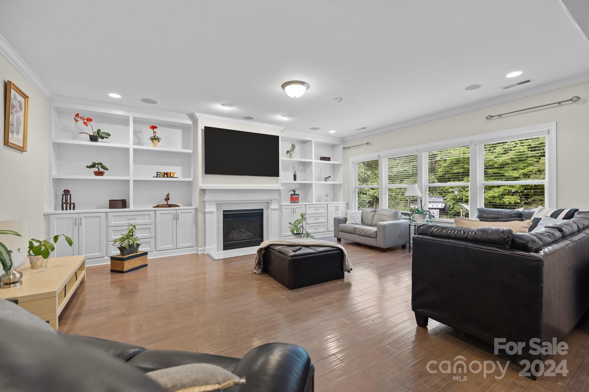 2061 Fuschia Court Fort Mill, SC 29708 - Photo 2 of 45 a living room with furniture a fireplace and a flat screen tv