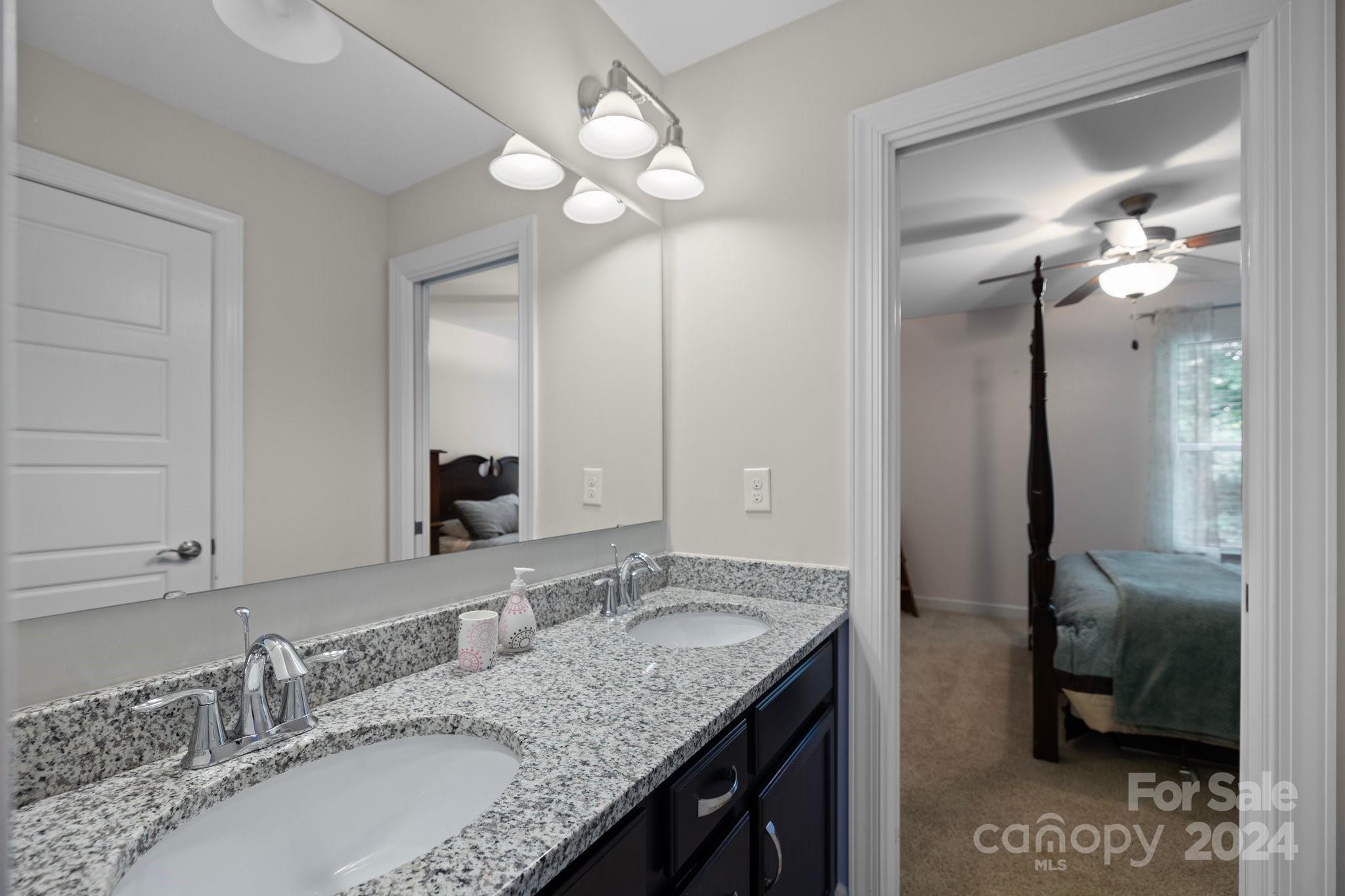 2061 Fuschia Court Fort Mill, SC 29708 - Photo 24 of 45 a bathroom with a granite countertop sink a light fixture and a mirror