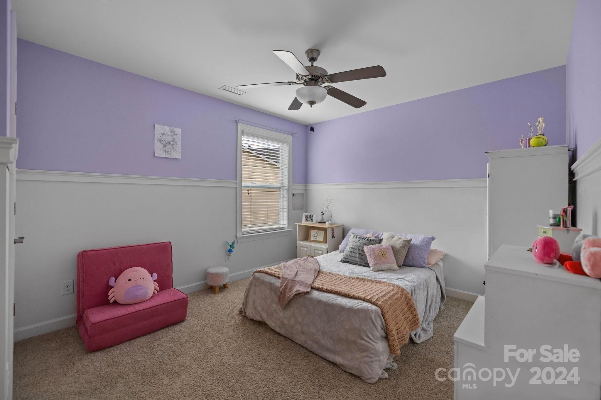 2061 Fuschia Court Fort Mill, SC 29708 - Photo 25 of 45 a bedroom with a bed and a chandelier