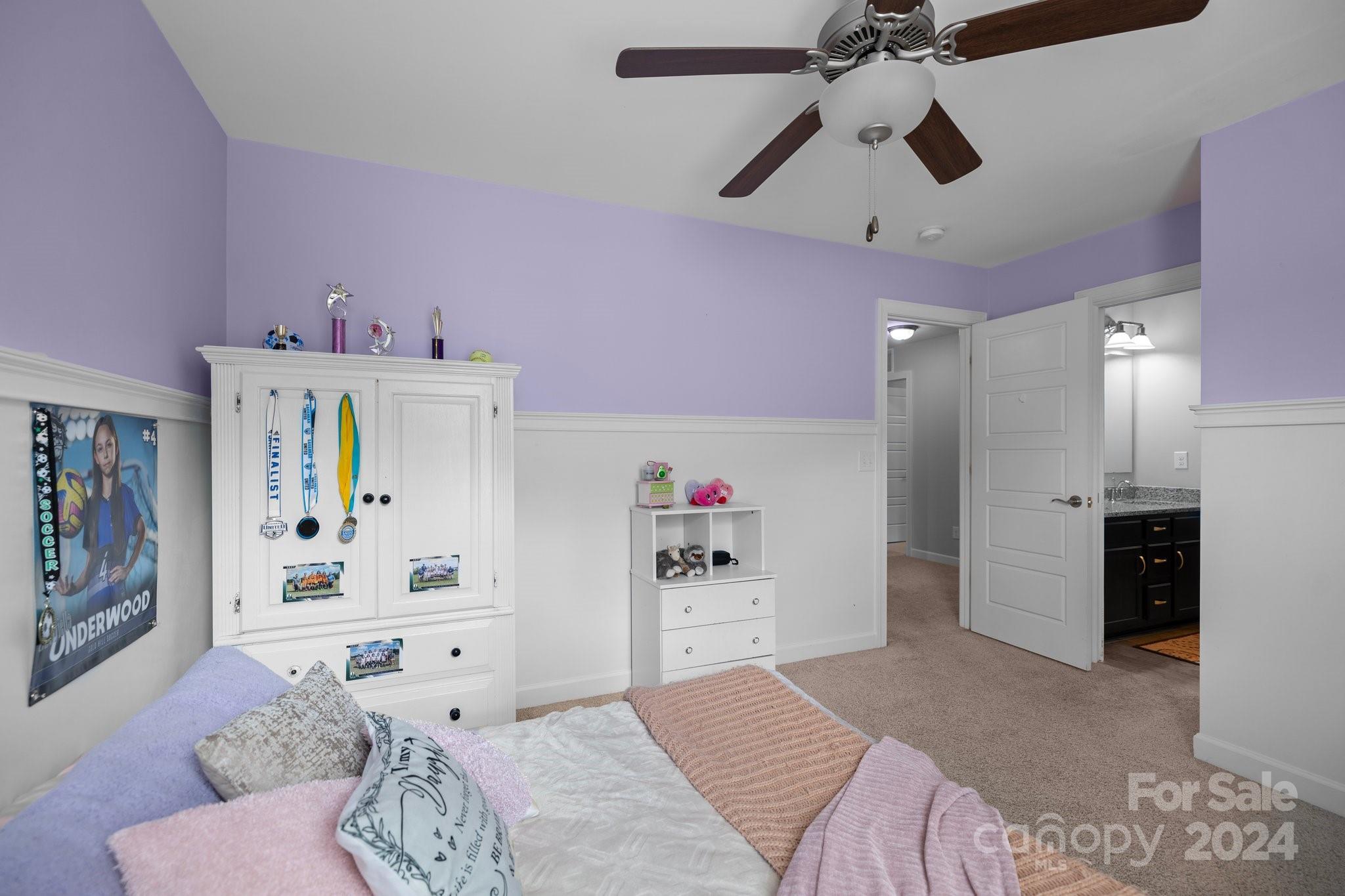 2061 Fuschia Court Fort Mill, SC 29708 - Photo 26 of 45 a bedroom with furniture and a chandelier