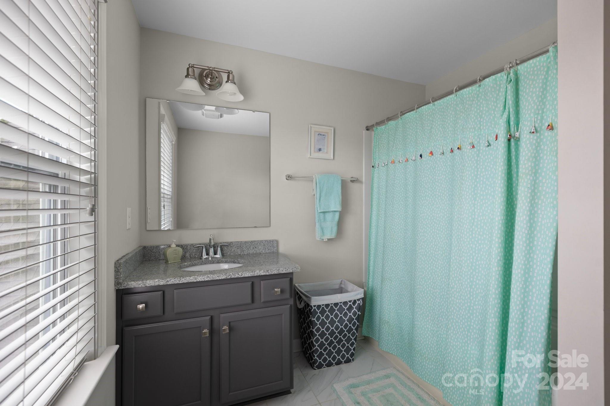 2061 Fuschia Court Fort Mill, SC 29708 - Photo 27 of 45 a bathroom with a sink vanity granite and a mirror