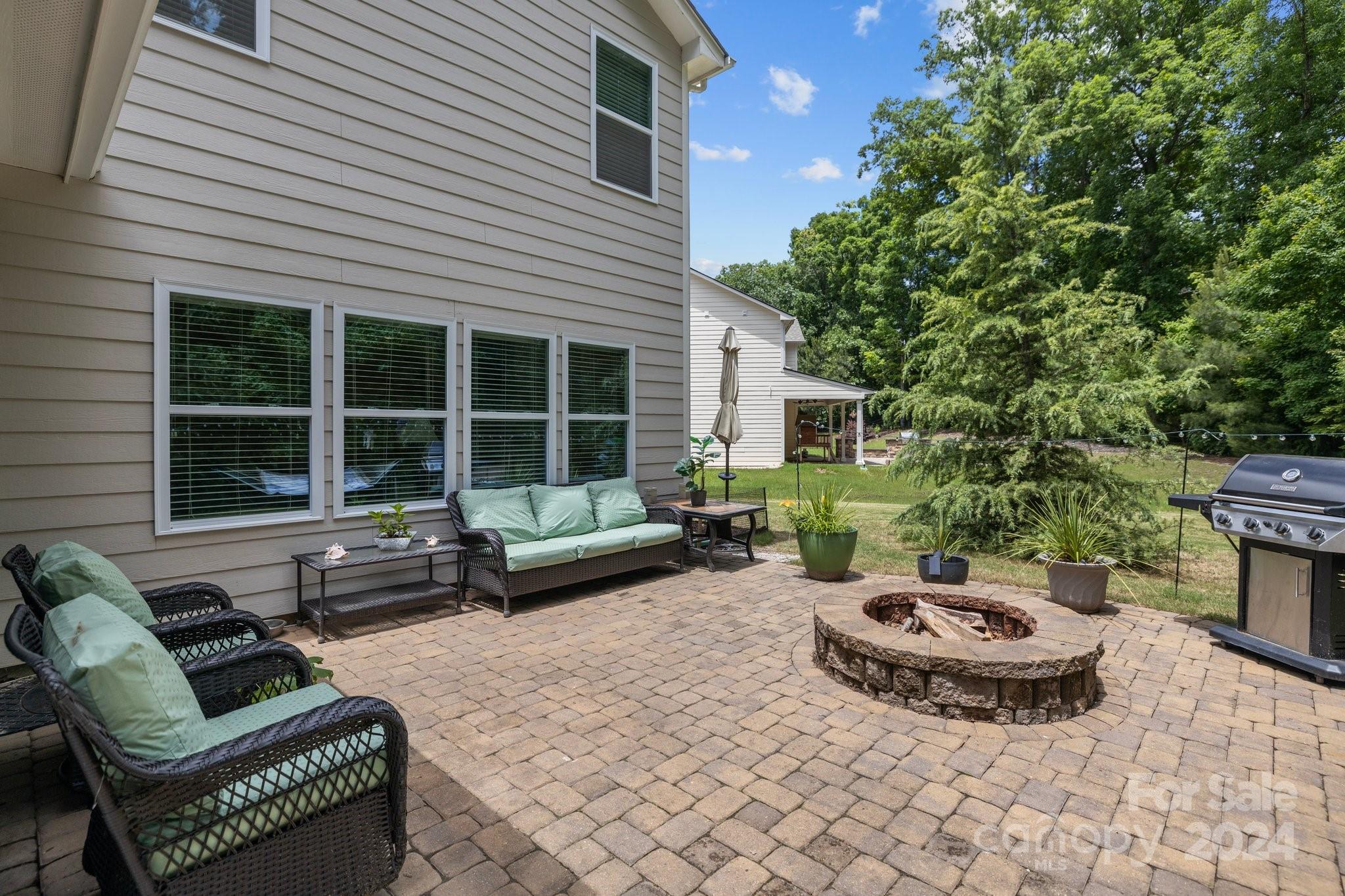 2061 Fuschia Court Fort Mill, SC 29708 - Photo 35 of 45 a view of a patio with couches table and chairs and potted plants