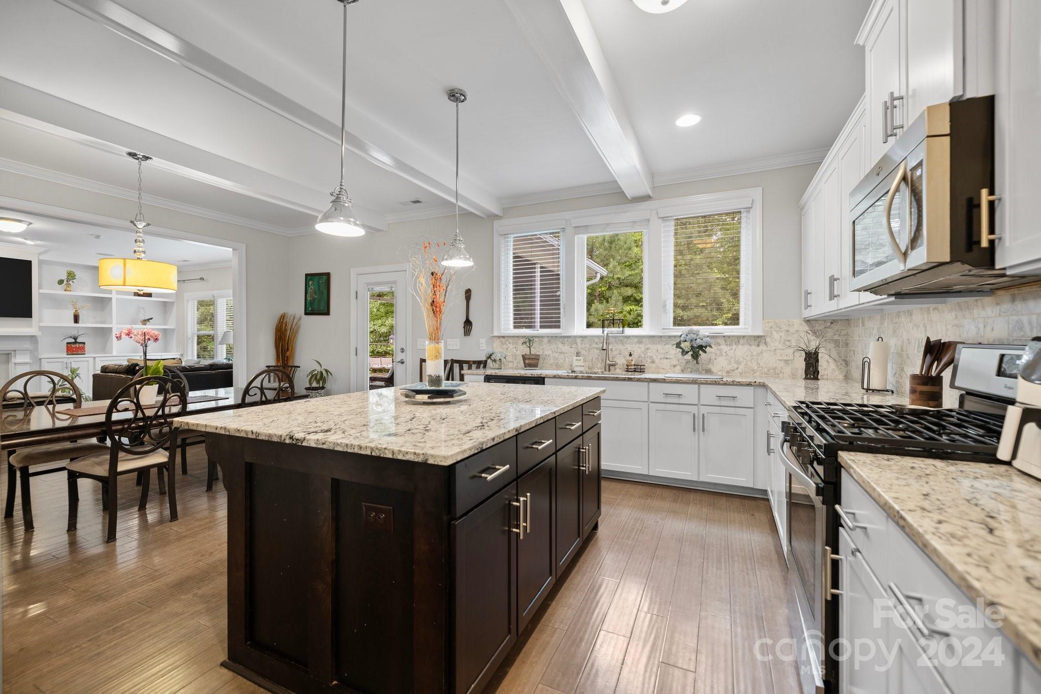 2061 Fuschia Court Fort Mill, SC 29708 - Photo 7 of 45 a kitchen with a stove a sink a center island and a window