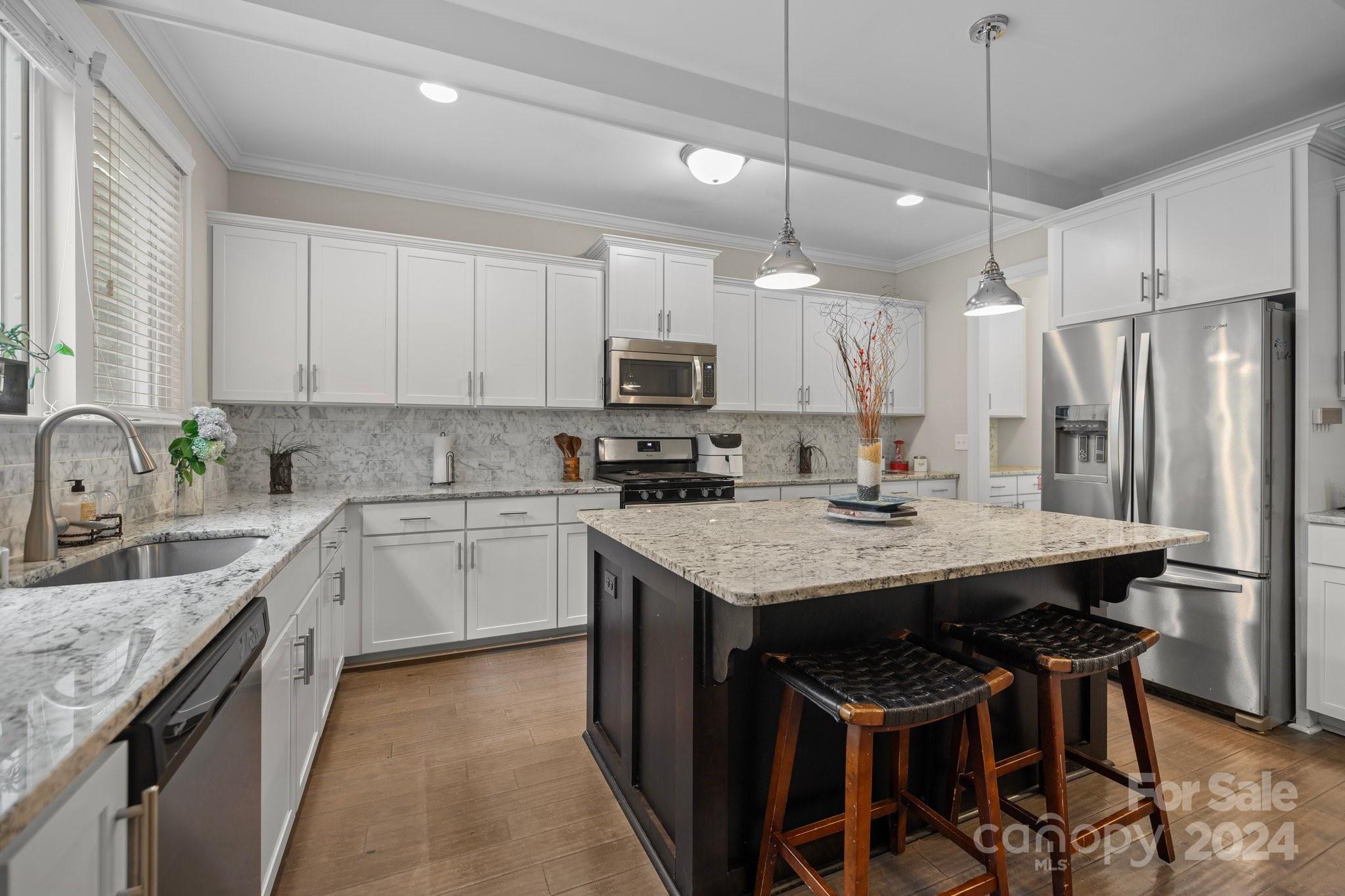 2061 Fuschia Court Fort Mill, SC 29708 - Photo 8 of 45 a kitchen with stainless steel appliances granite countertop a sink stove and refrigerator