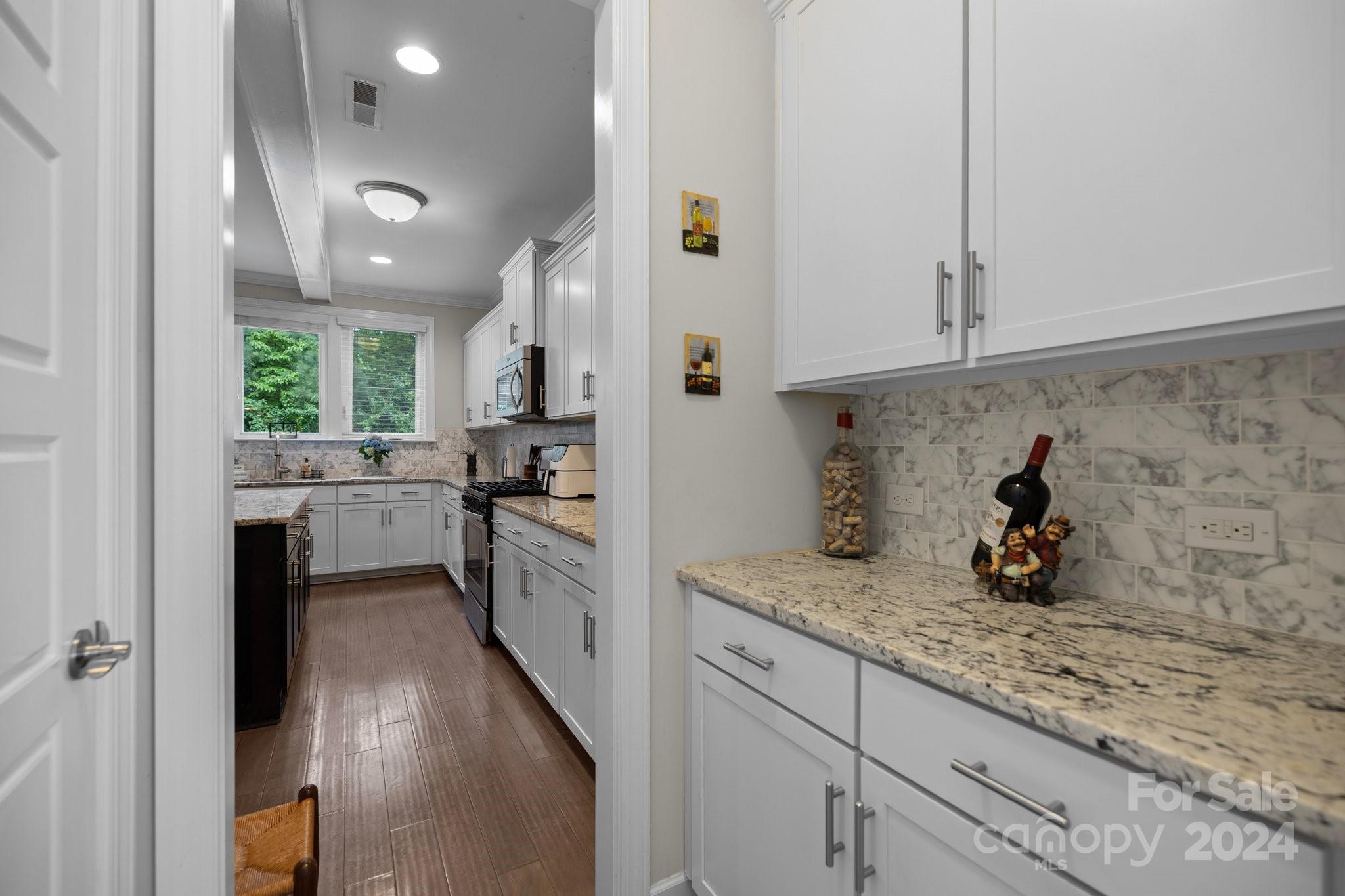 2061 Fuschia Court Fort Mill, SC 29708 - Photo 9 of 45 a kitchen with granite countertop cabinets stainless steel appliances a sink and a counter top space