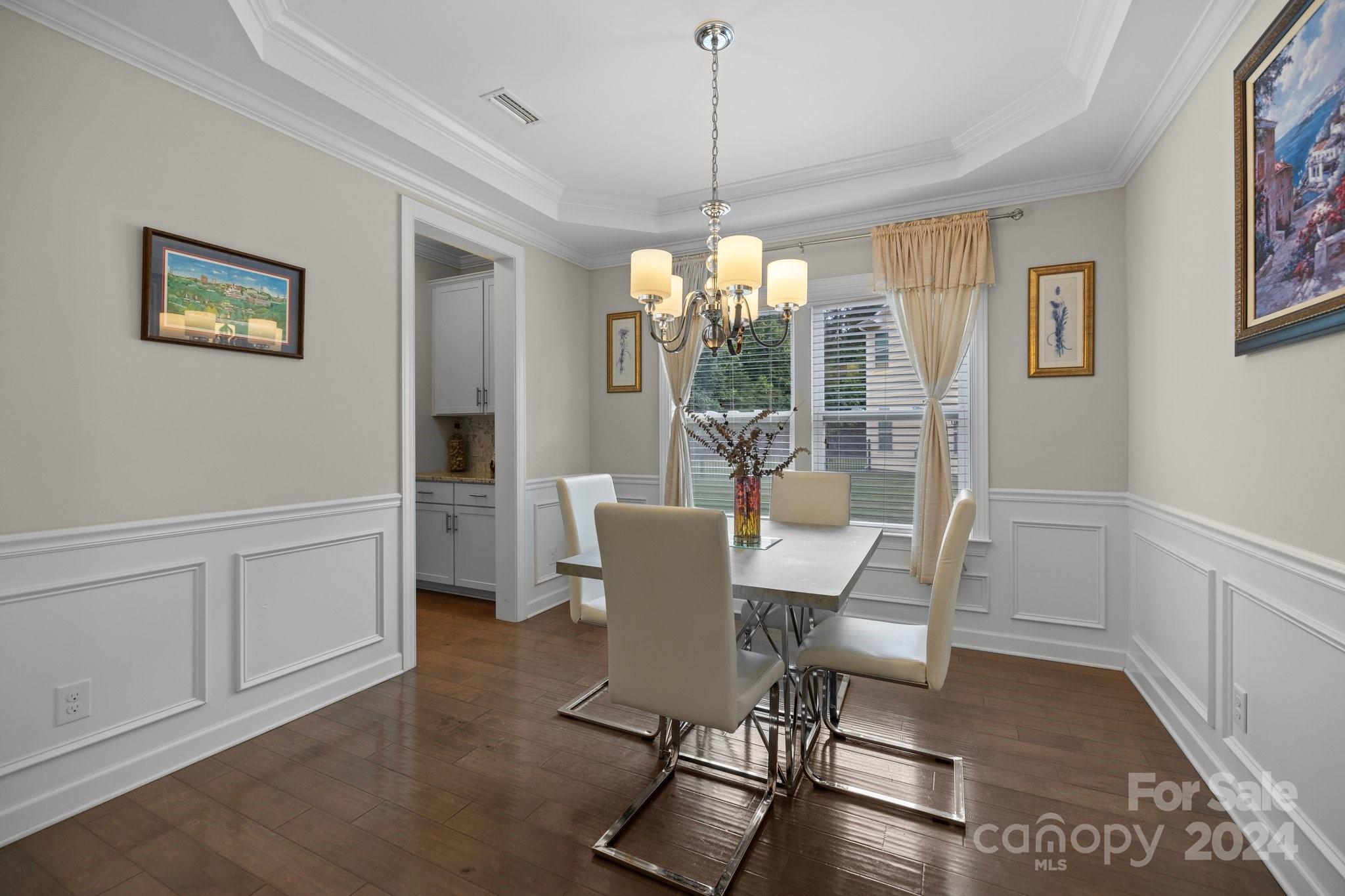 2061 Fuschia Court Fort Mill, SC 29708 - Photo 10 of 45 a dining room with furniture a chandelier and wooden floor
