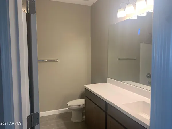 a bathroom with a sink a toilet and a window