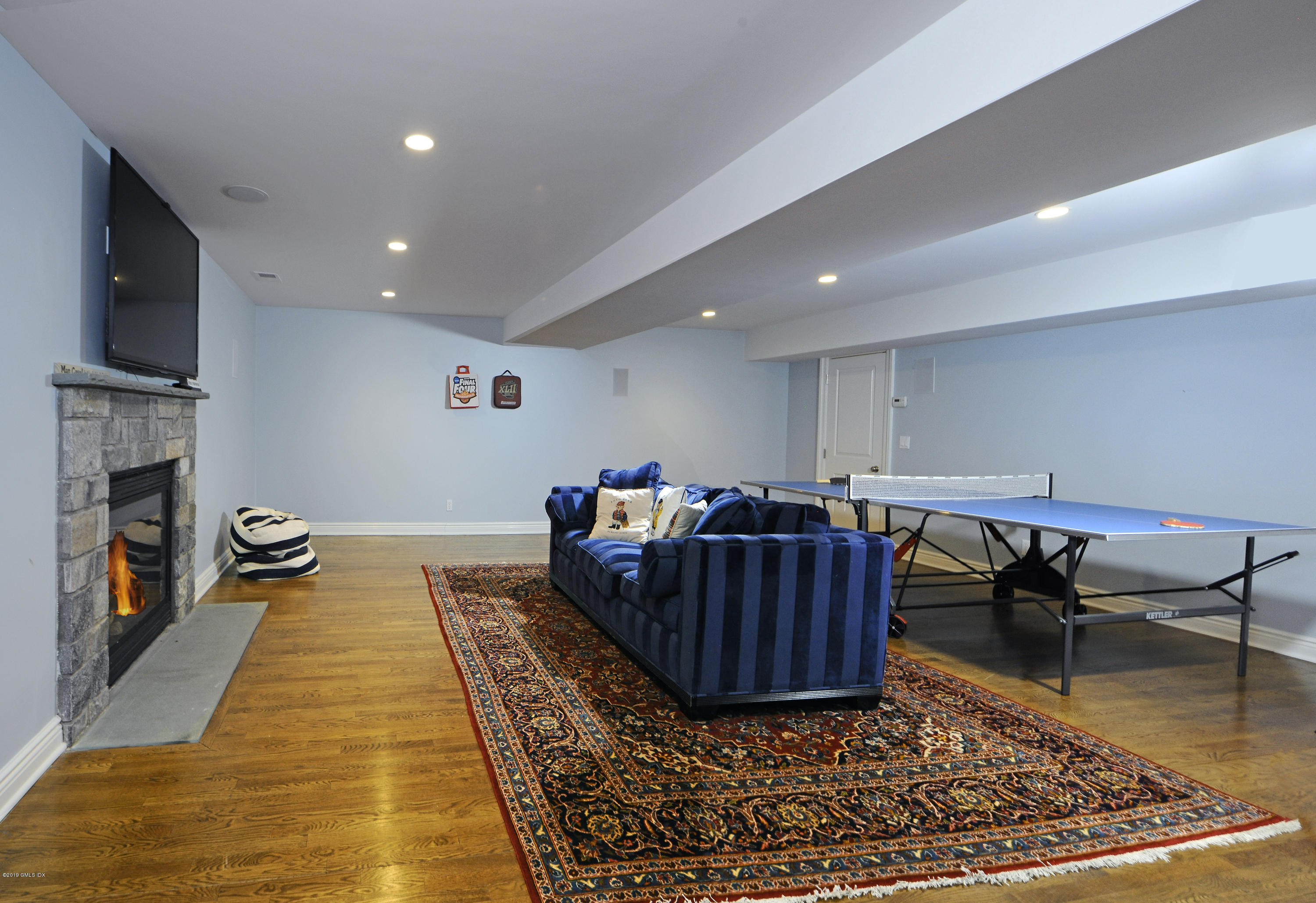 35 Beechcroft Road Greenwich, CT 06830 - Photo 18 of 21 a living room with furniture a flat screen tv and a rug