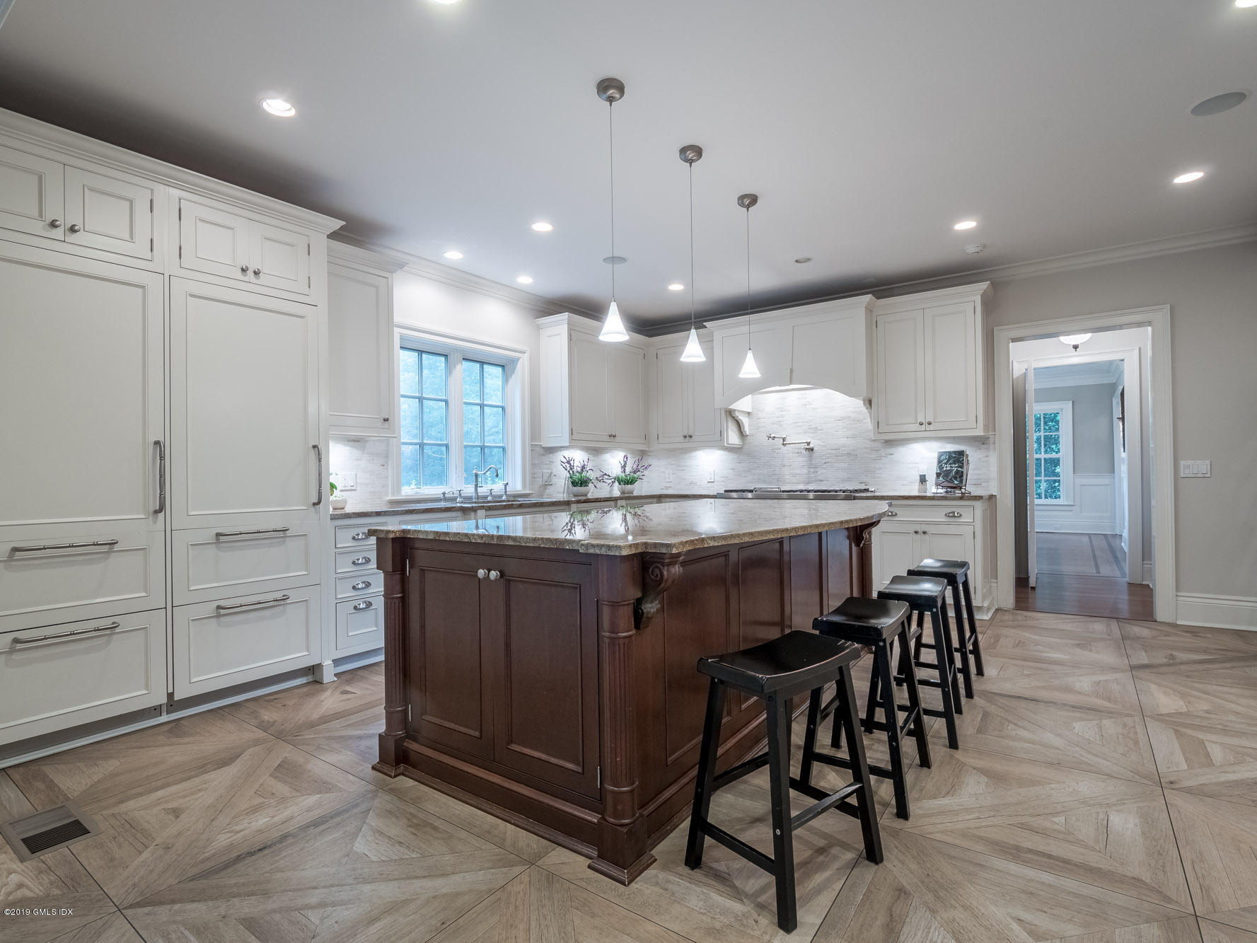 35 Beechcroft Road Greenwich, CT 06830 - Photo 5 of 21 a kitchen with kitchen island granite countertop wooden cabinets and center island