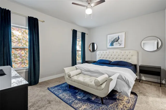 a bedroom with a large bed rug and window