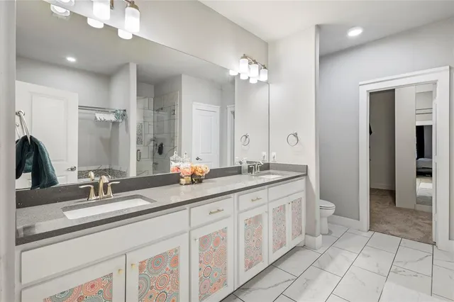 a bathroom with a double vanity sink and a mirror