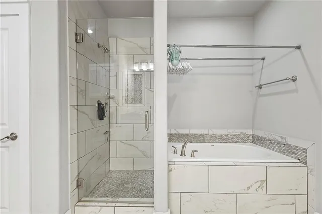 a bathroom with a bathtub and shower