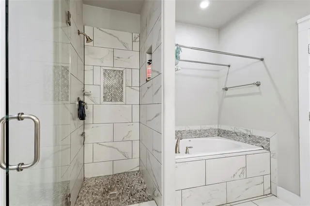 a bathroom with a bathtub and shower