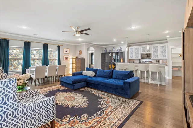 a living room with furniture wooden floor and a rug
