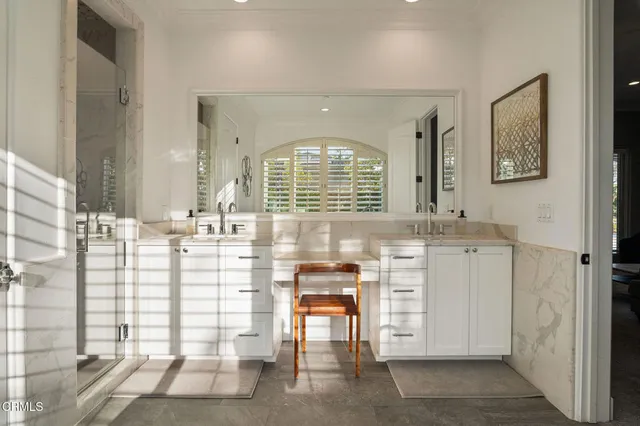 a bedroom with furniture and a flat screen tv