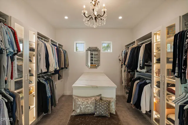 a bedroom with bed and a chandelier