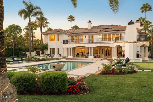 a view of swimming pool with outdoor seating and plants