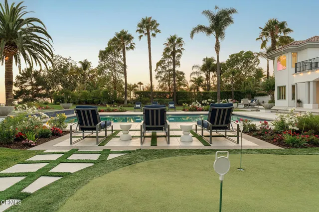 a view of a swimming pool with outdoor seating