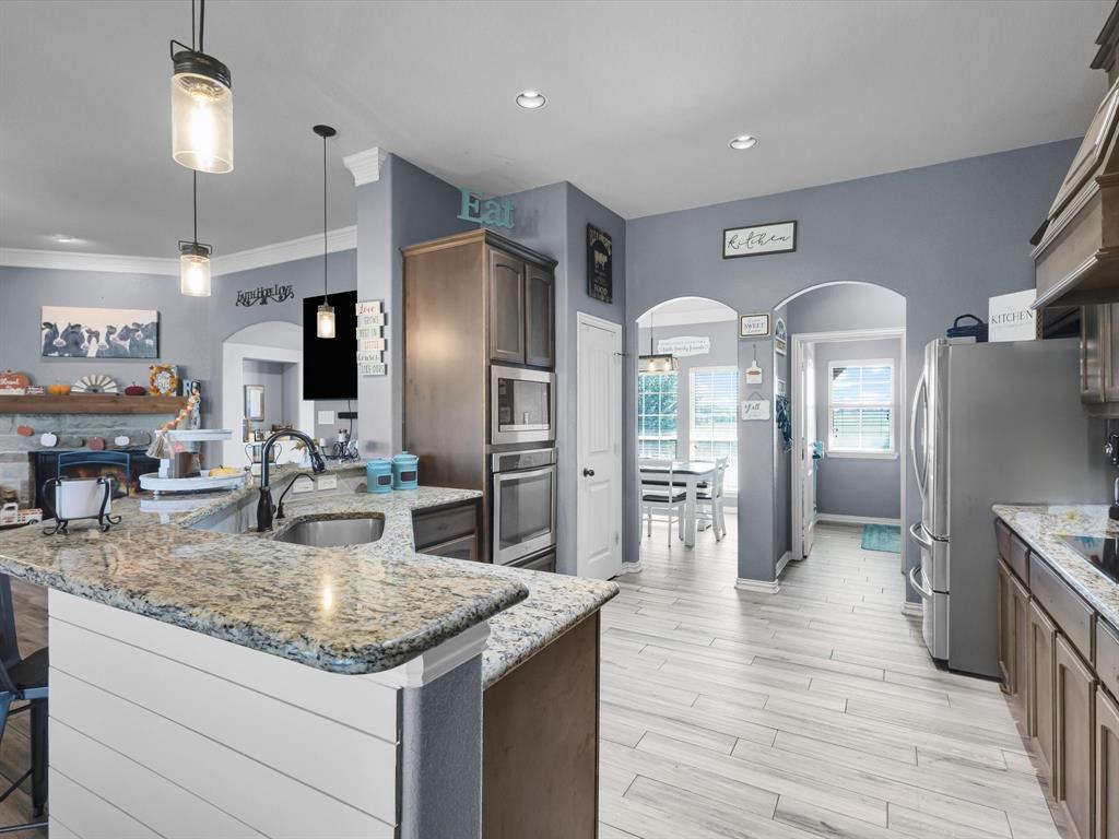 128 County Road 4430 Decatur, TX 76234 - Photo 12 of 34 a kitchen with stainless steel appliances granite countertop a refrigerator a stove and a sink