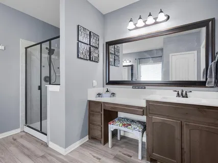 a view of a kitchen with fridge and workspace