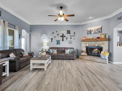 a living room with furniture and a fireplace