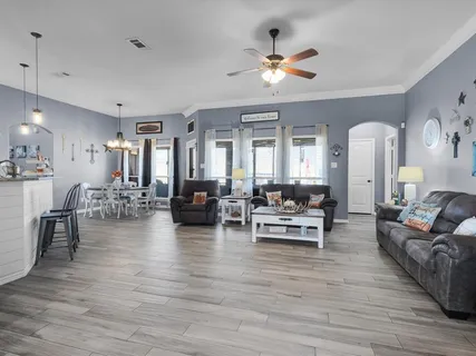 a living room with furniture and wooden floor