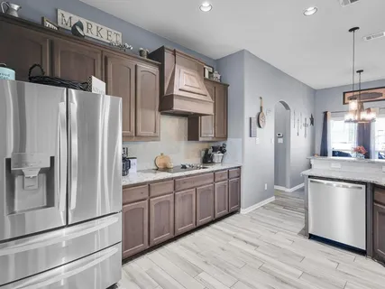 a kitchen with stainless steel appliances granite countertop a refrigerator sink and cabinets