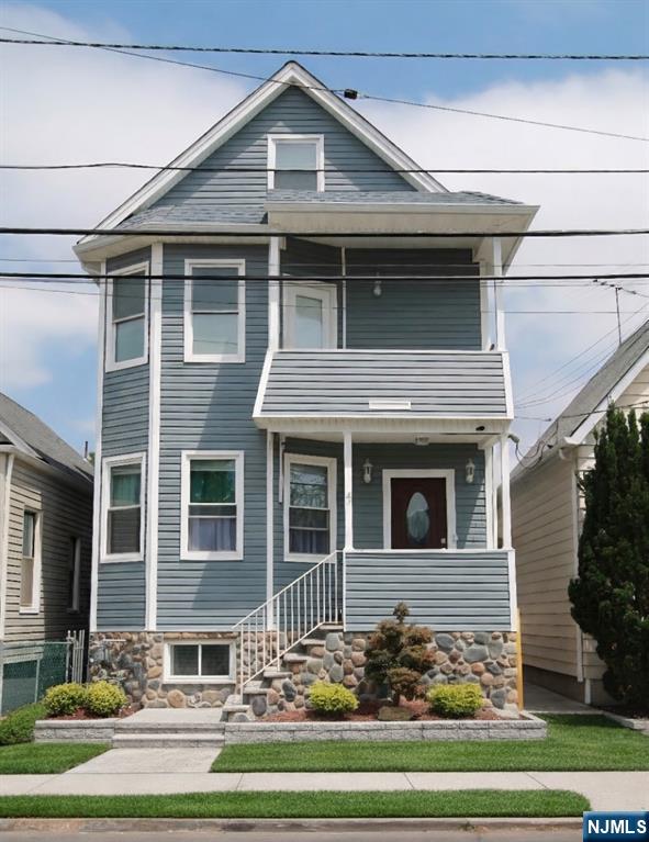 47 Maple Avenue, Unit 2 Wallington, NJ 07057 - Photo 6 of 7 a front view of a house with a yard
