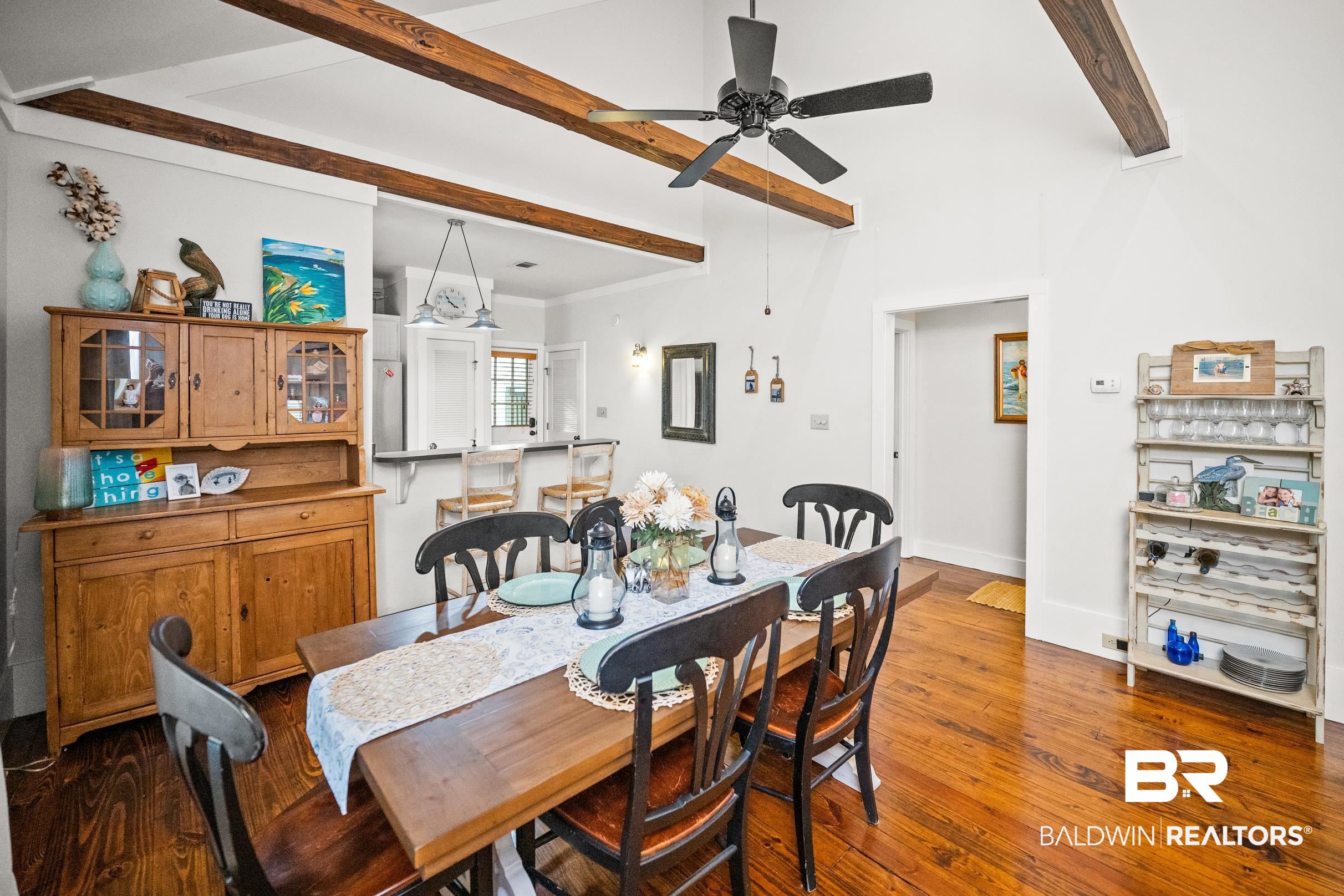25773 Canal Road, Unit 18 Orange Beach, AL 36561 - Photo 3 of 44 Dining space with wood-type flooring, beam ceiling, and ceiling fan